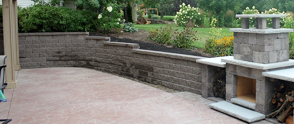 Retaining wall built by a patio and fireplace in Urbandale, IA.