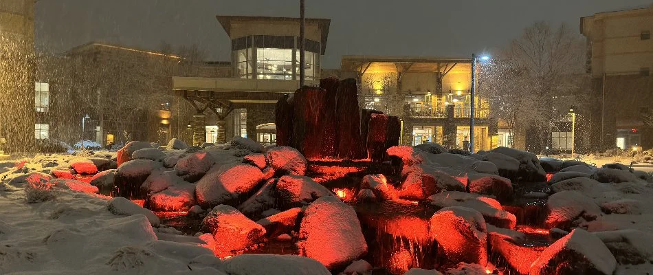 Water feature in front of a building in Lakewood, IA, with outdoor lighting.